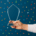 Hand holding a glass tourism award trophy with confetti falling, symbolizing recognition and success in the travel industry